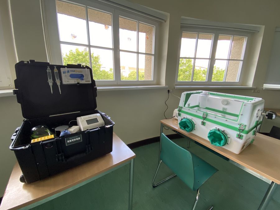 Left: suitcase lab, for mastermix preparation and assay performance; right: secure glove box for safe sample inactivation and handling